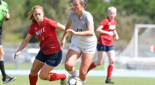 Haley Cook keeps the ball away from her opponent.