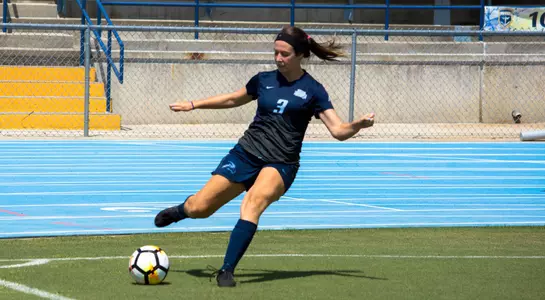 Chloe DiDonato kicks the soccer ball away from the sides.