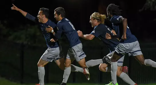 Men's soccer team celebrates goal at JU game