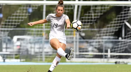Amber Jones kicks the soccer ball.
