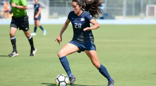 Andrea Sanchez is guarding the soccer ball.