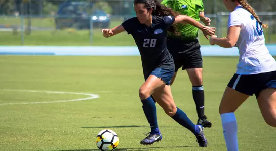 Andrea Sanchez keeps the ball away from her opponent.