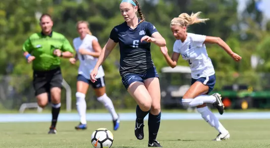 Brandi Walker kicks the ball away from her opponent.
