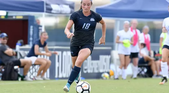 Hannah Menendez kicks the soccer ball.