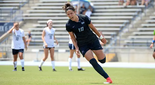 Thais Reiss celebrates against Charleston Southern after scoring a goal.