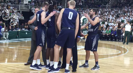 Team huddle on the floor at Michigan State prior to season opening tipoff
