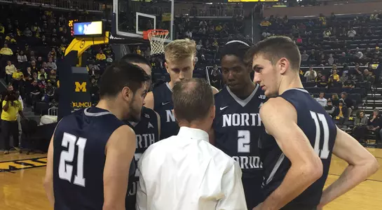 North Florida men's basketball teams huddles together prior to start of game at Michigan