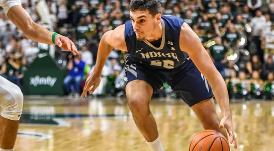 Trip Day dribbles the ball toward the lane