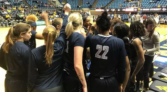 Women's basketball huddles at West Virginia