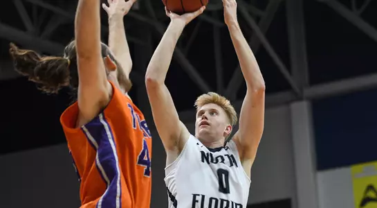 Noah Horchler shoots a jump shot over a defender's hand