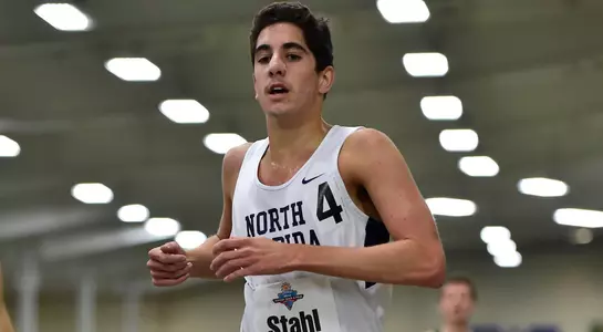 Tyler Stahl crosses the finish line in the Mile race