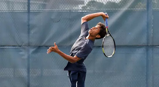 Sahil Deshmukh serving at the base line.