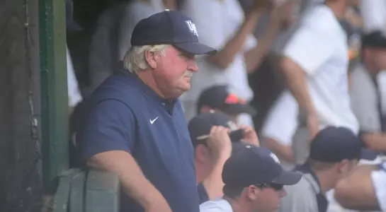 Smoke Laval stands in the dugout giving instructions to his Osprey baseball team