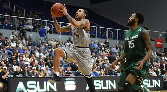 Dallas Moore drives to the basket past Jacksonville defender.
