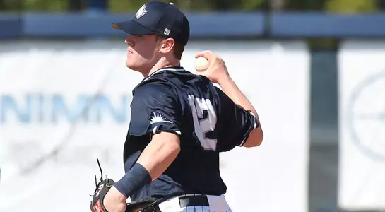 Mac Wilson holds the ball before firing it to first base for the out