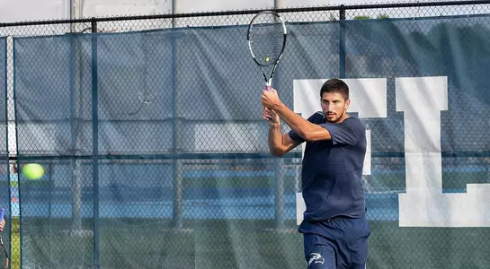 Jefta Kecic returns the ball over the net with a backhand