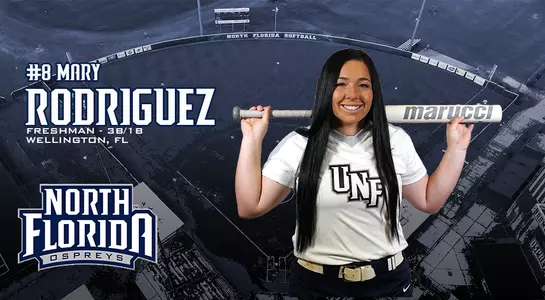 Mary Rodriguez poses with a bat. She is a freshman from Wellington, Fla.