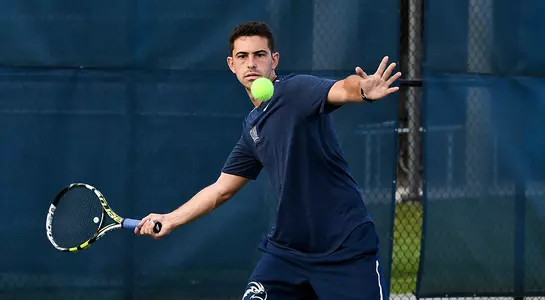 Goldberg returns a serve over the net.