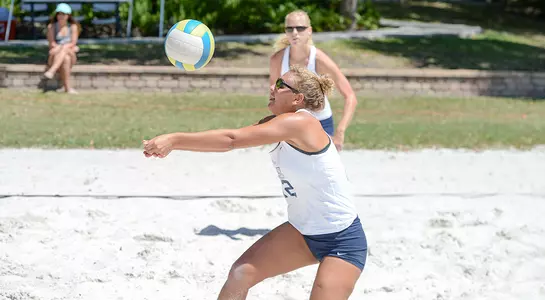 Debolt digs the ball against Jacksonville with McPherson waiting to attack.