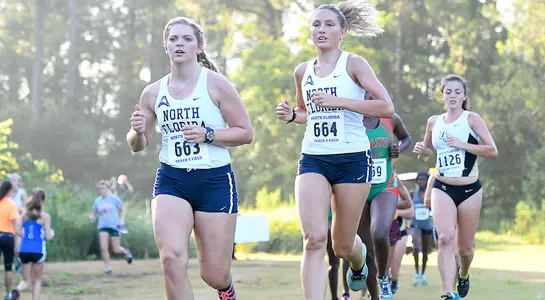 Harley Horsley runs along side her teammate