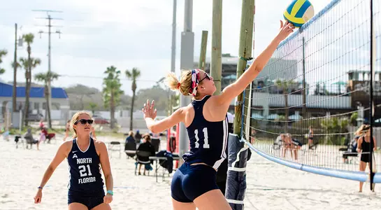 Sami Mims tips the volleyball over the net