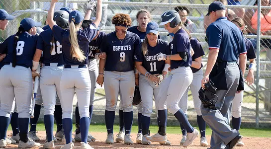 The softball team celebrates Alex Arciola's homerun