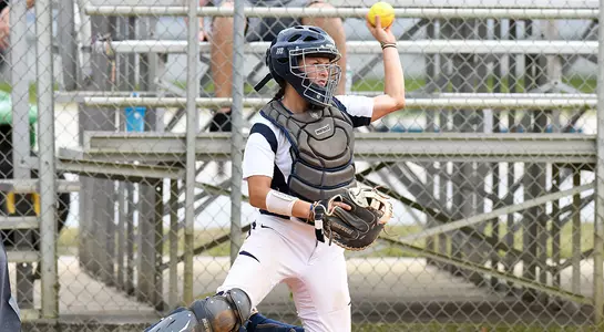 Alex Arciola throws the softball back to the pitcher