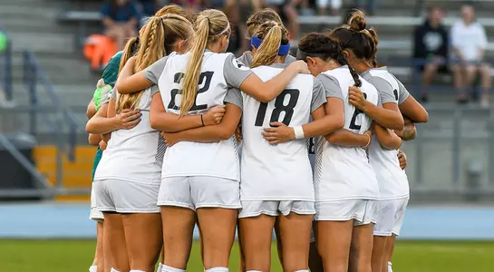 Several UNF players huddle before a game