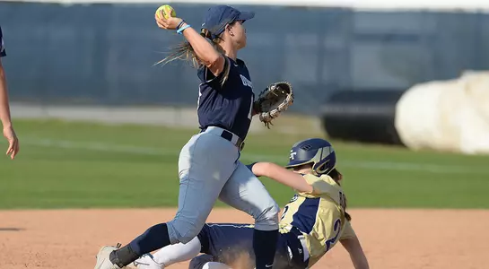 Macayla Kelley throws the softball to first base