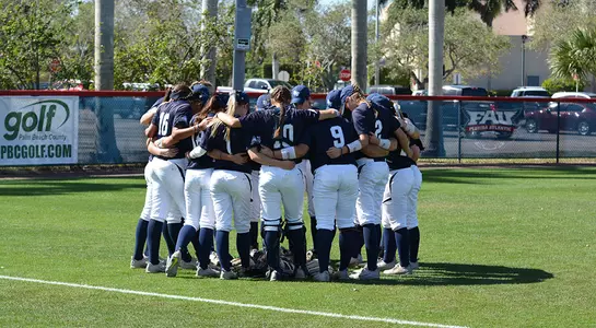 The softball team huddles before a game