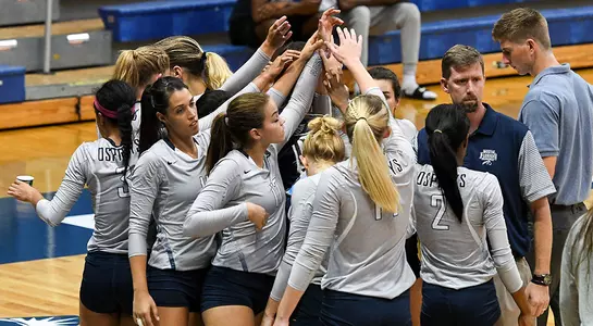 The volleyball team huddles before a game