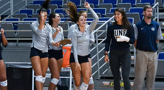 several UNF players celebrate on the sideline