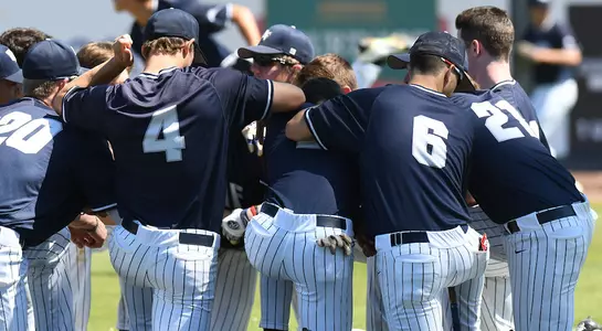 The baseball team huddles before a game