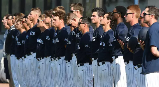 The baseball team stands for the national anthem