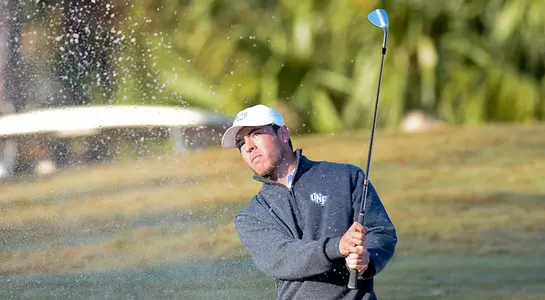 Jordan Batchelor hits a sand shot from a bunker