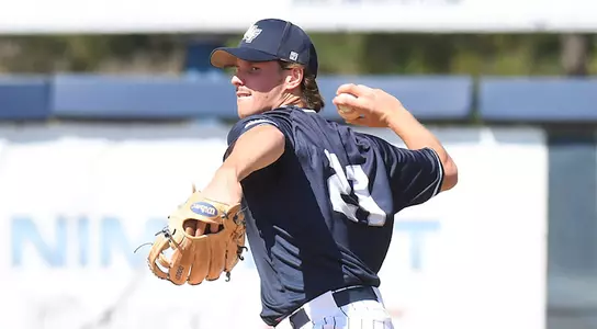 Chris Berry throws the baseball to first base