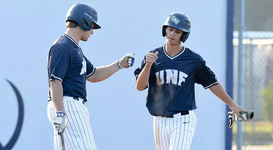 Dalton Board and Blake Voyles celebrate near homeplate