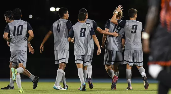 Men's soccer celebrates after a goal against Campbell in the home opener.