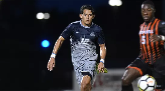 Adrian Nunez goes for the soccer ball against Campbell.