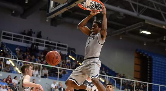 Wajid Aminu dunks the basketball