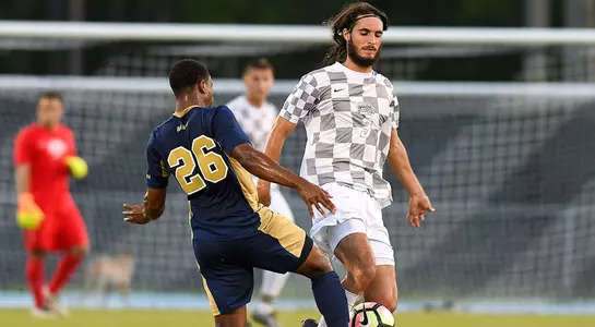 Cormac Dodd dribbles past an FIU player