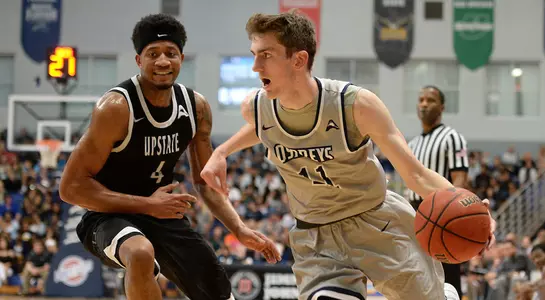 Garrett Sams dribbles past a USC Upstate player