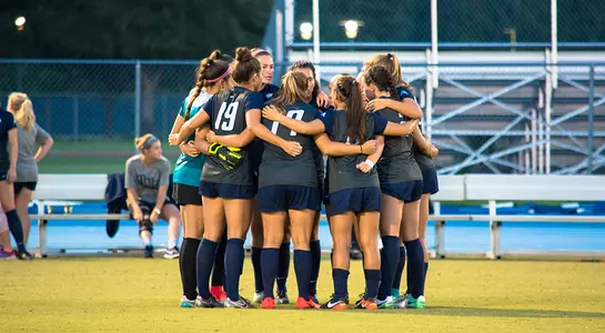 Women's soccer huddles before a game at Hodges.
