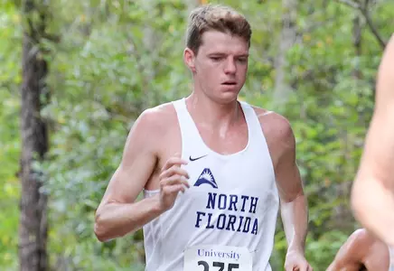 Nick Morken runs on trail of UNF XC Course