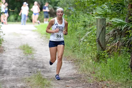 Crystal Liebenberg runs on trail in UNF XC Invitational