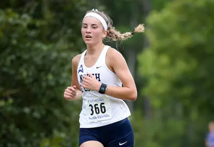 Crystal Liebenberg pumps her arms down the stretch of the UNF XC Invitational