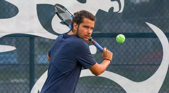 Alberto DeMeo returns the ball at the UNF Tennis Courts