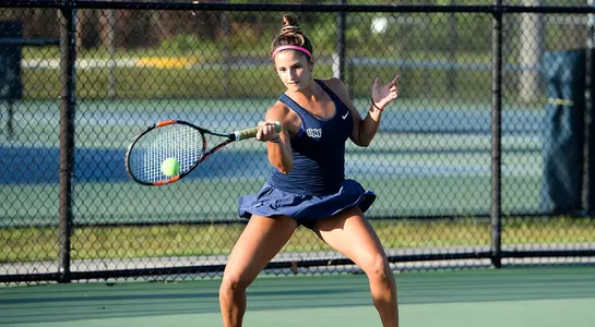 Florencia Rossi returns the tennis ball over the net.