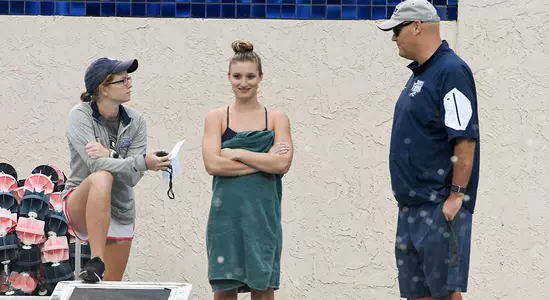 Swim coaches talking to Taylor Schmidinger