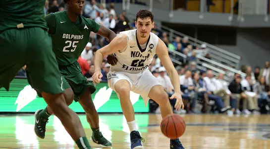 Trip Day dribbles past JU.